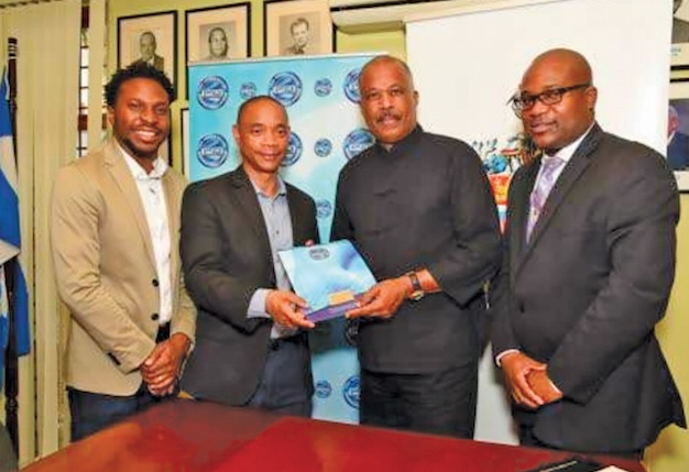 CEO, Private Sector Organisation of Jamaica (PSOJ), Dennis Chung (second left) and Vice-Chancellor, Professor Sir Hilary Beckles (second right) following the signing of a Memorandum of Understanding establishing the joint innovation committee to drive research and innovation. They are flanked by PSOJ member, Twain Richardson (left) and Pro Vice-Chancellor, Planning, The UWI, Professor Densil Williams.