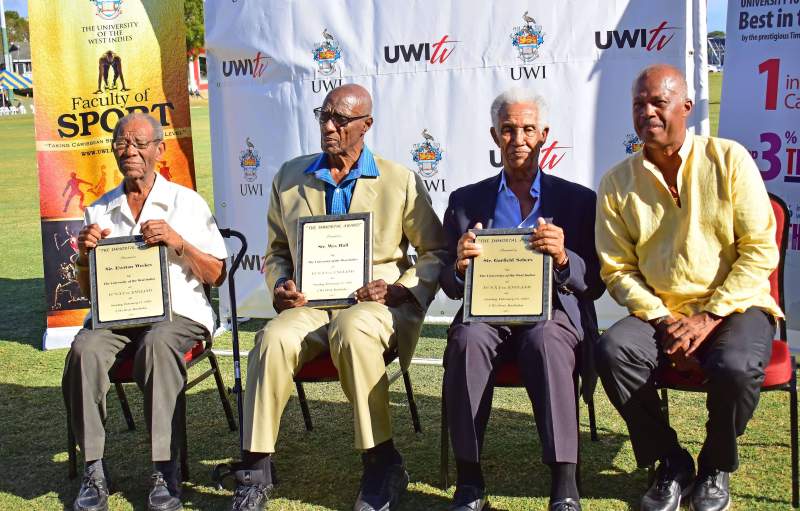 From left: West Indian "Immotals" Sir. Everton Weeks, Sir. Wes Hall and Sir. Garfield Sobers seated with The UWI Vice-Chancellor, Professor Sir Hillary Beckles during a ceremony at the UWI Vice Chancellor's Cricket Match on February 17, 2019.