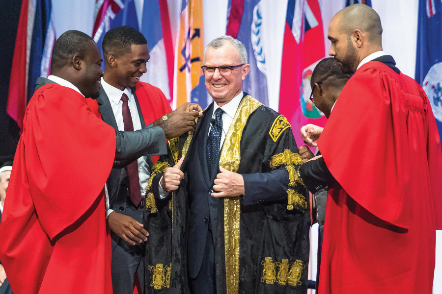 As part of the installation ceremony's ritual, Chancellor Bermudez is robed by the Presidents of the Student Guild Councils across the four campuses.